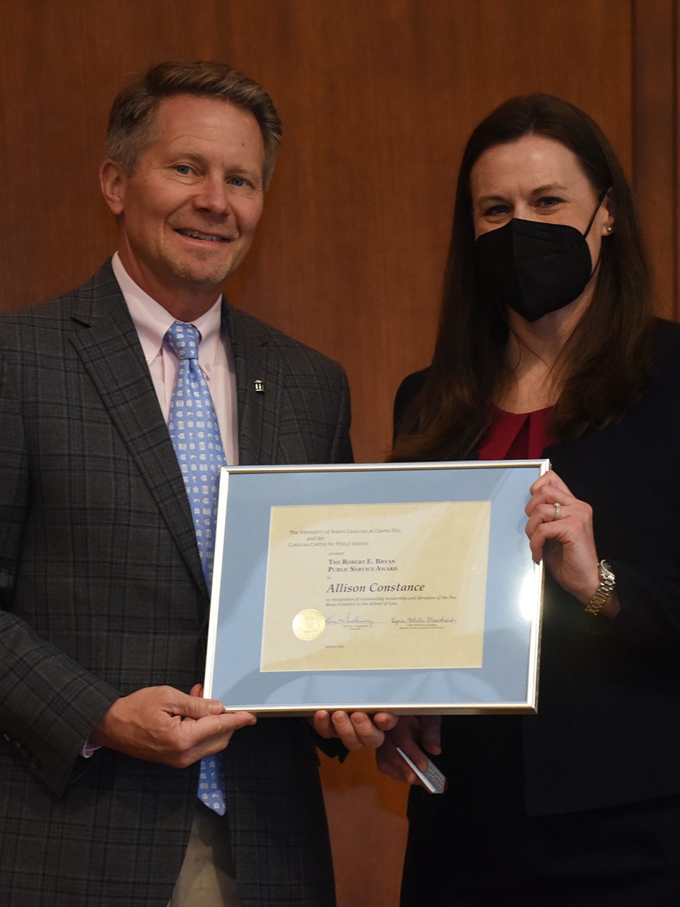 Allison Standard Constance poses with UNC Chancellor Kevin Guskiewicz after receiving the Robert E. Bryan Public Service Award.