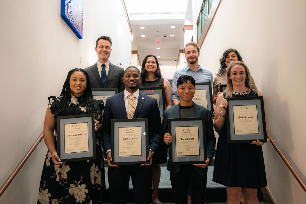 Jaazaniah Catterall, Grace Henley, J Hallen, Caroline Randive, Adreanna Sellers, Trey Ellis, Le Ho, and Julie Leopold pose with their plaques after being inducted to the Davis Society