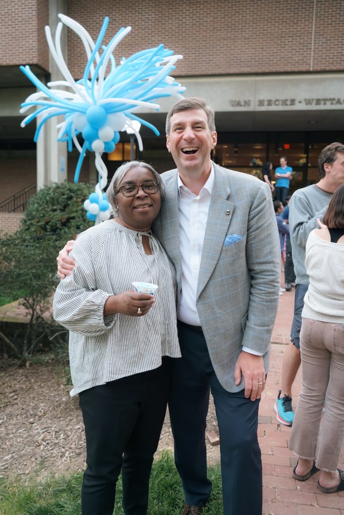 Fredia Banks-Marsh poses with Scott Peeler with a balloon bouquet behind them outside of the law school side entrance.
