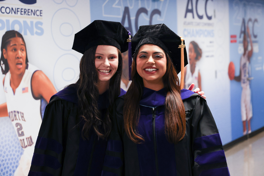 3L Class President Sabrina Shah and Hannah Long pose in the tunnel before processing into commencement.