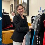 student with clothes rack